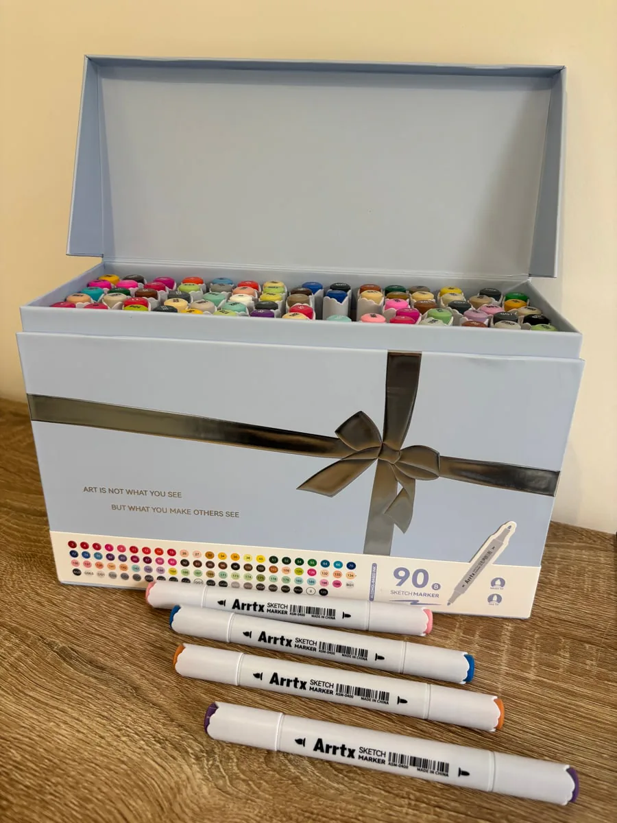 Open Arrtx box holding the 90 markers, with four markers laid out in front